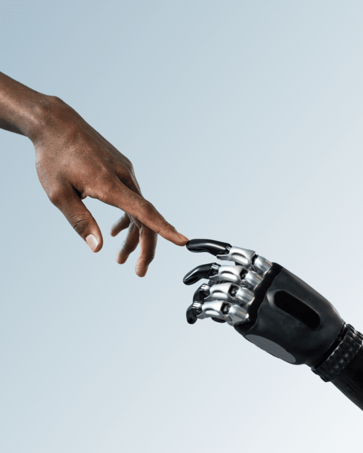 human hand and robotic hand touch fingertips